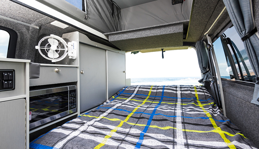 VW T6 Transporter Frontline Campervan interior rear cabin sleep configuration opened out to beach